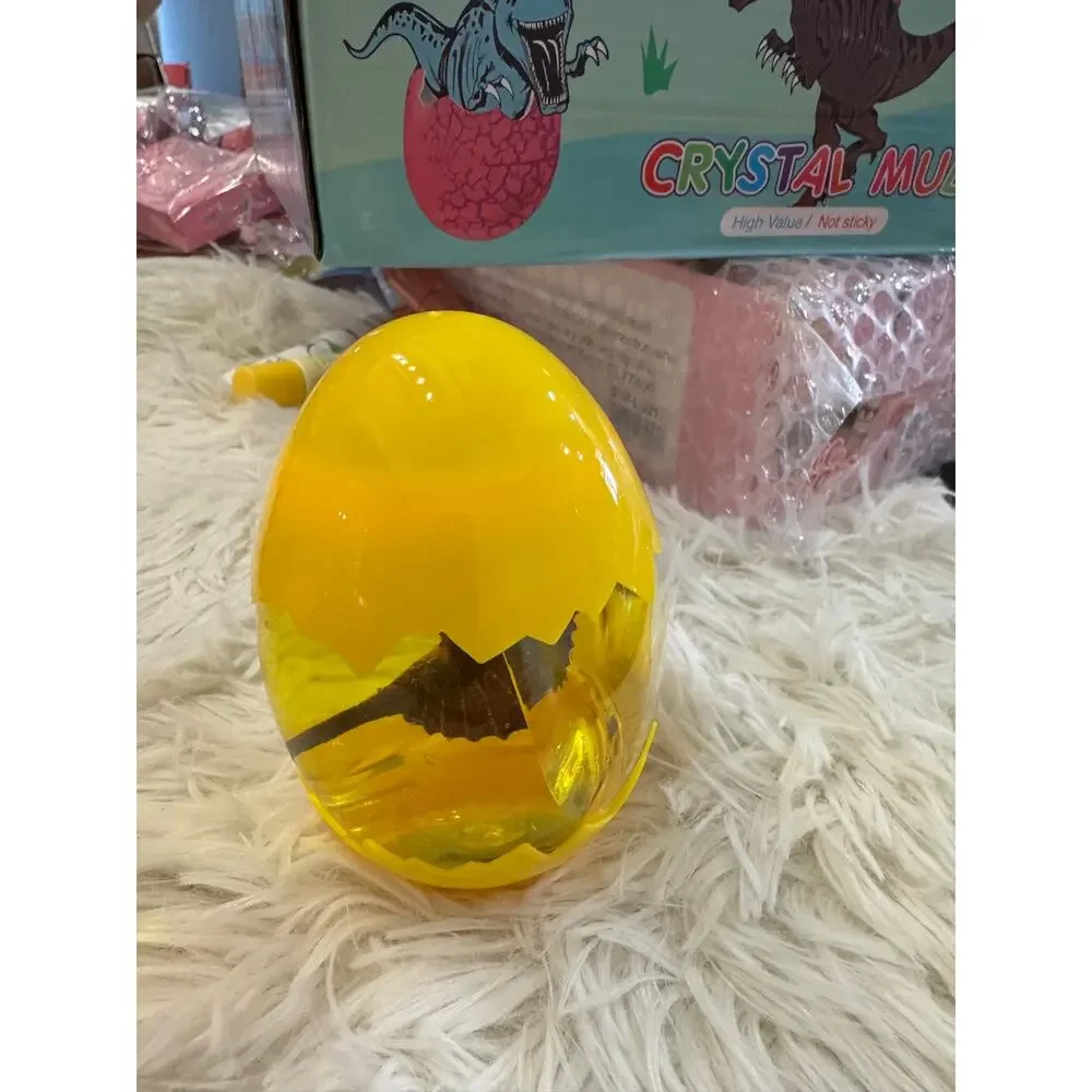 Yellow slime dinosaur egg with a assorted dinosaurs inside